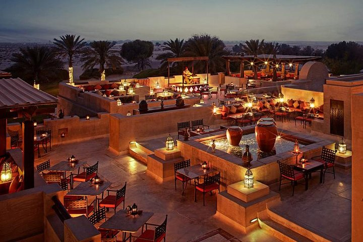 Experience the magical charm of Bab Al Shams Desert Resort as you dine under starlit skies surrounded by the serene beauty of the desert landscape and elegant Arabian design.